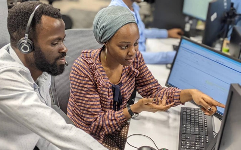 Serious diverse programmers using tablet